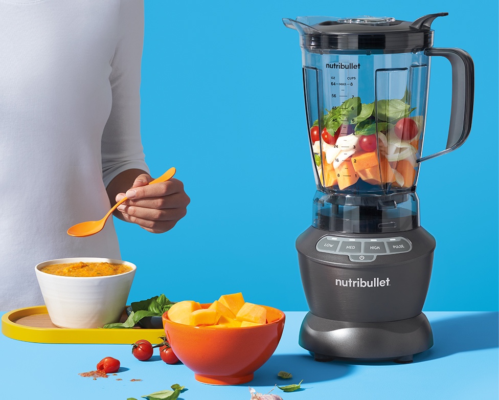 Person holding blended smoothie with nutribullet blender